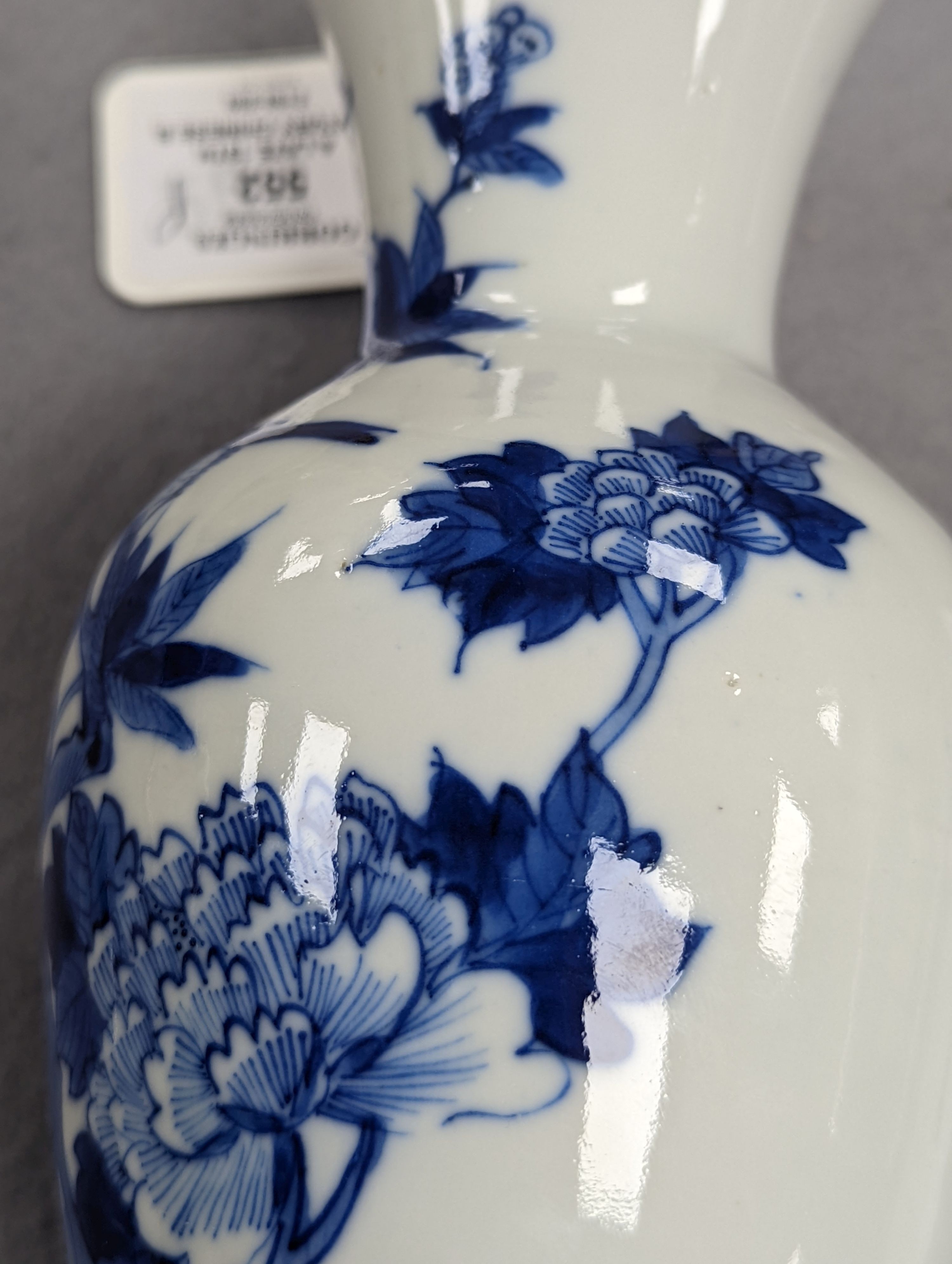 A late 19th century Chinese blue and white baluster vase, painted with birds amid flowers and rock work, pseudo Kangxi mark. 26cm